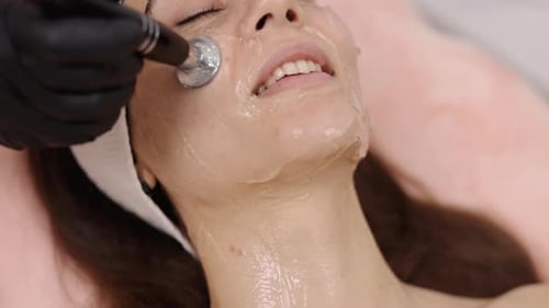 Woman Receives Facial Treatment at Skincare Clinic