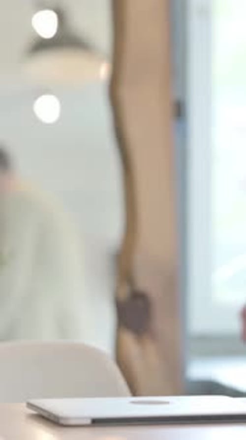 Young Businessman Coming to Office and Starting Work on Laptop, Vertical Video