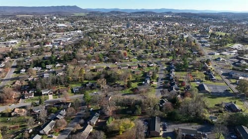 Suburb neighborhood on sunny day in United States. Downtown of small american city in background. Fo