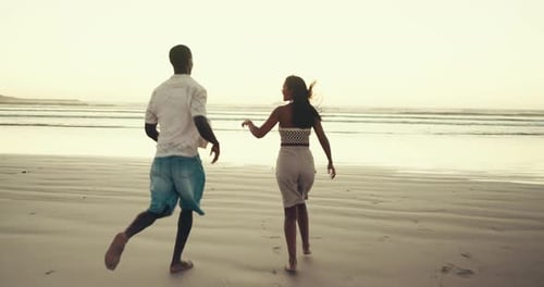 Couple, back and holding hands with running to ocean, support and trust in relationship