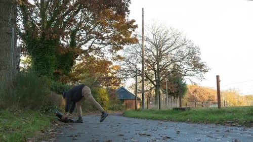 Couple stands by beach watching seals, bundled up on a quiet winter day in Scotland