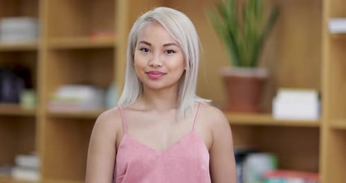 Smiling woman with blonde hair looking at camera