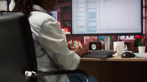 System Administrator Types Code Into PC Developing Software