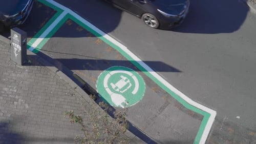 Painted sign indicates electric vehicle recharging parking point on the city street