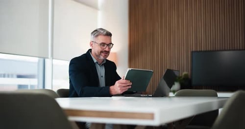 Businessman, reading and tablet in office with laptop for research, financial proposal and audit