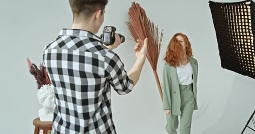 Male Photographer Working with Female Model in Studio
