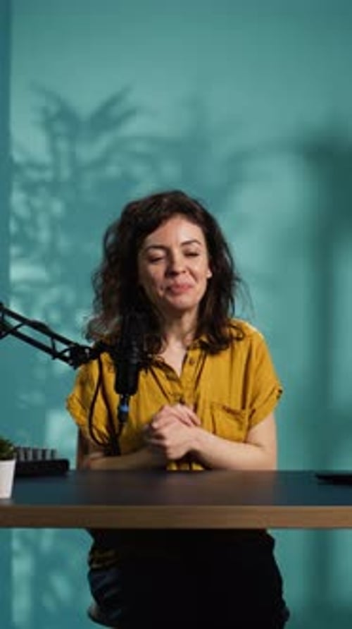 Vertical Video Smiling Woman in Studio Using Professional Camera to Record Video