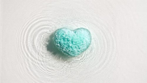 Teal Heart Bath Bomb Rippling in Clear Water