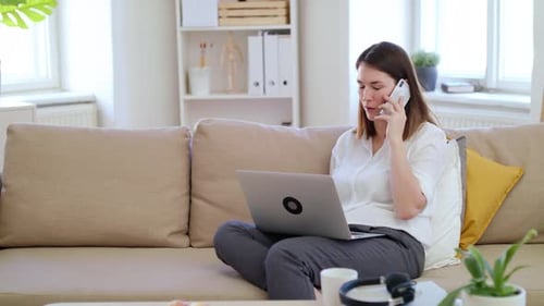 Businesswoman with Laptop and Smartphone Working in Home Office Quarantine Concept