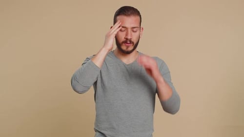 Adult Man with Headache Massages Temples