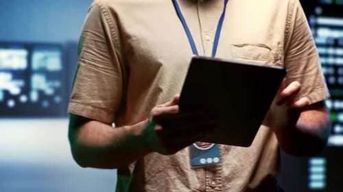 Man Using Tablet in Technology Workplace Setting