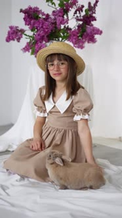 Girl Pets Rabbit in Spring Easter Portrait