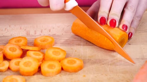 Slicing Fresh Carrot on a Cutting Board