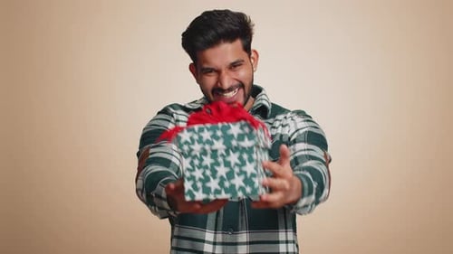 Smiling Man Giving a Wrapped Gift