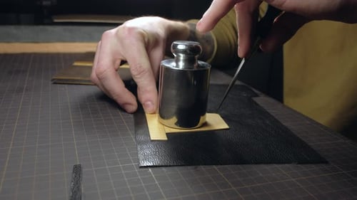 Hands of a Person Who Works with Leather in Workplace
