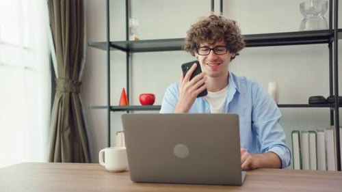 Young Adult Working at Laptop in Home Office