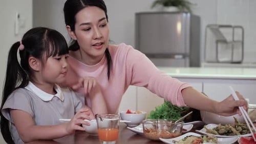 Mother and Daughter Enjoying Lunch at Home