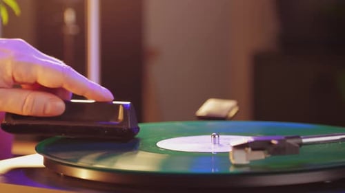 Hand Cleaning Green Record on Turntable Close Up