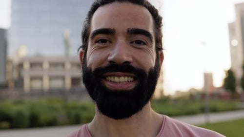 Man Smiling Towards Camera in City Close Up