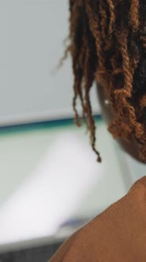 African American Woman Studies at Home Using Modern Laptop
