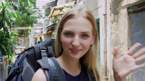 Portrait of Beautiful Backpacker Tourist Girl Waving at Camera on Bangkok Asian