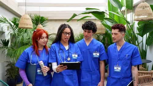 Group of medical students discussing patient information on a tablet