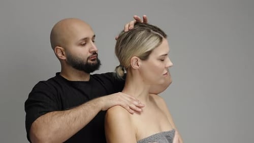 Therapist Guides Cervical Spine Assessment and Neck Stretching Using Manual Techniques Showing