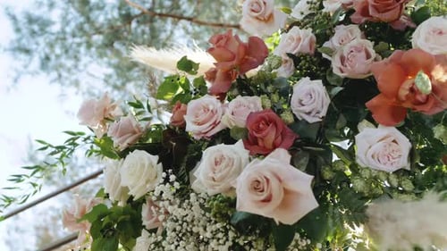 Closeup Bouquet of of Fresh Pink and Yellow Roses with Green Leaves Wedding Arch Details