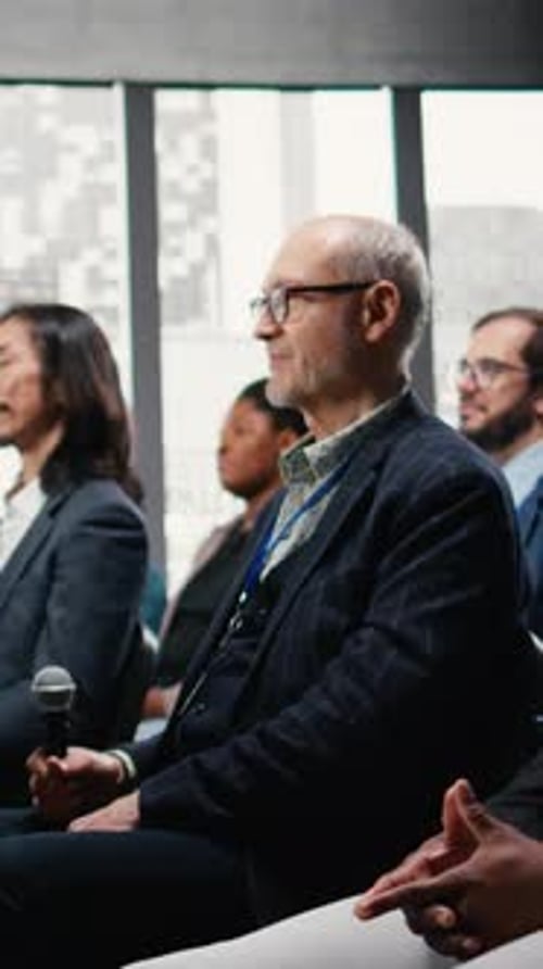 Business People Listening and Asking Questions at Conference