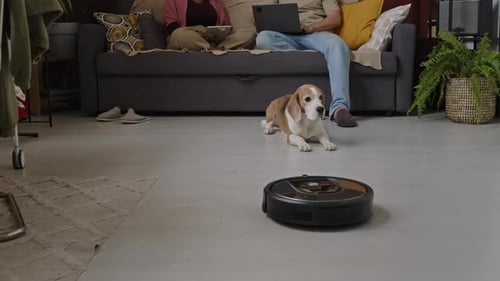 Robot Vacuum Cleans Home While Couple Relaxes