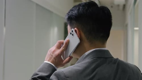 Back View Asian Businessman Speak in Office Hallway Male Middleaged Professional Entrepreneur