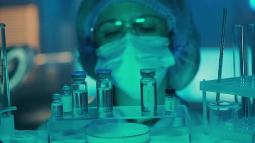 Scientist Examines Vaccine Vials in a Laboratory Setting