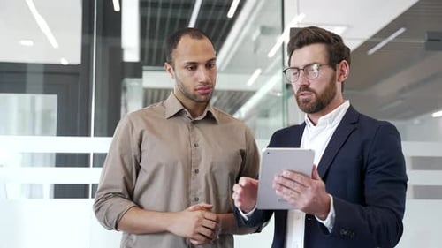 A businessman praises a colleague with a handshake for good results, achievements, congratulates