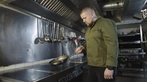 Professional Chef Cooking Food in Commercial Kitchen