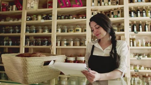 Young woman shop assistant working in a sustainable zero waste store