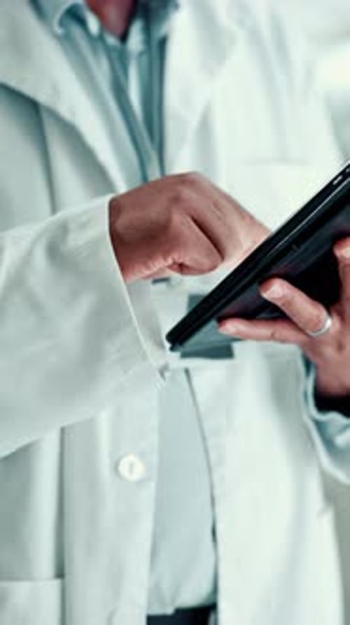 Doctor using Tablet in Hospital Setting