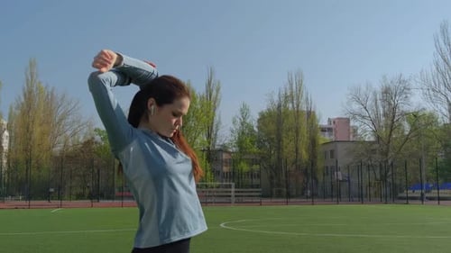 Young Woman Doing Hand Stretching At The Stadium Before Training