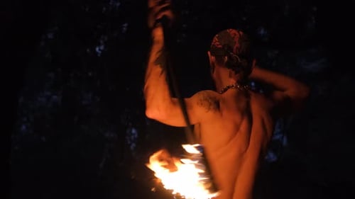 Bearded Man Performs Fire Dancing in the Night