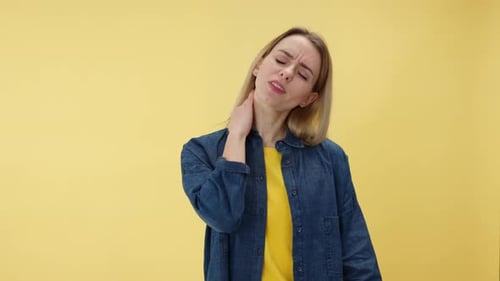 Blonde Woman Massaging Stiff Neck