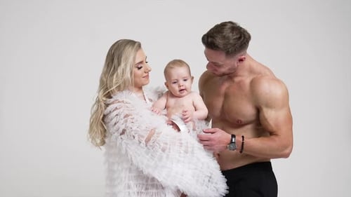 Attractive Family Poses in Studio With Newborn Baby