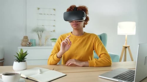 Young Adult Using Virtual Reality Headset at Desk