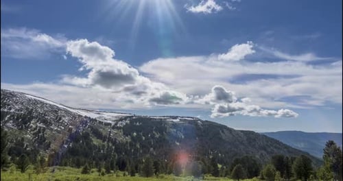 Majestic Mountains and Dynamic Sky in Sunny Day