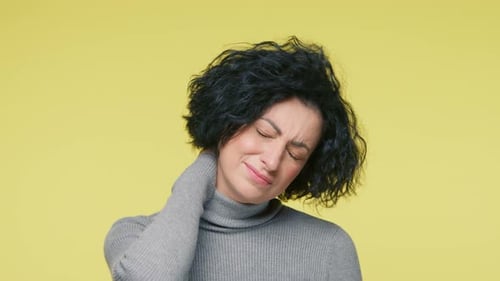 Woman Rubbing Sore Neck in Close Up Shot