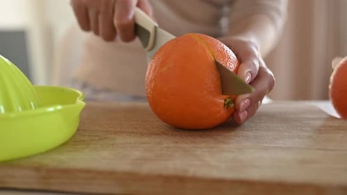 Bright Orange Cut in Half on Cutting Board