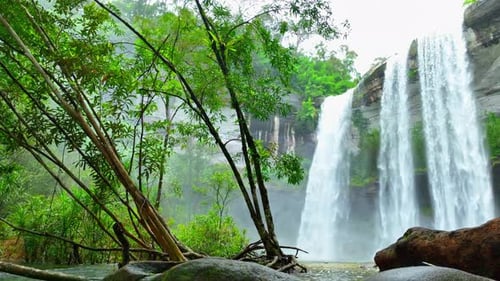 Stunning waterfall cascading from towering cliff.