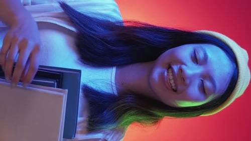 Smiling Young Adult Holding Books
