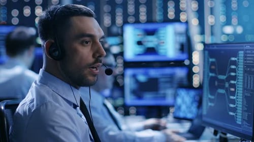 In the System Control Center Technical Support Team Gives Instructions with the Help of the Headset