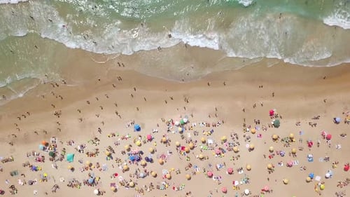Summertime in a public Beach with colorful umbrellas