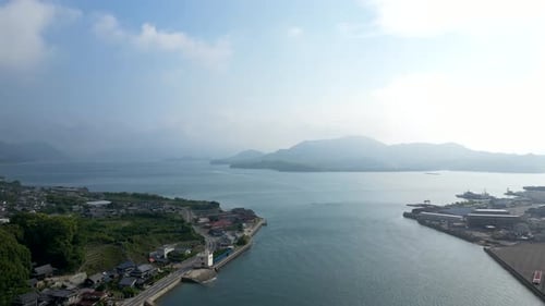 Slow aerial drone forward flight over small ocean inlet in between islands