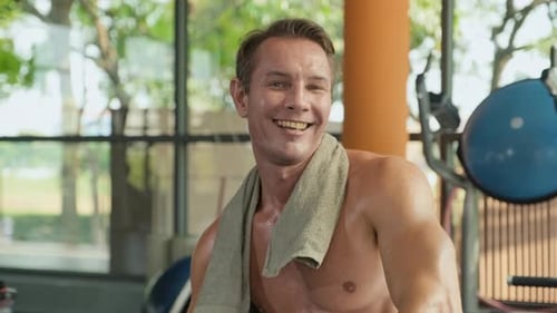 Adult Muscular Man Smiling and Looking at Camera after Training in Gym